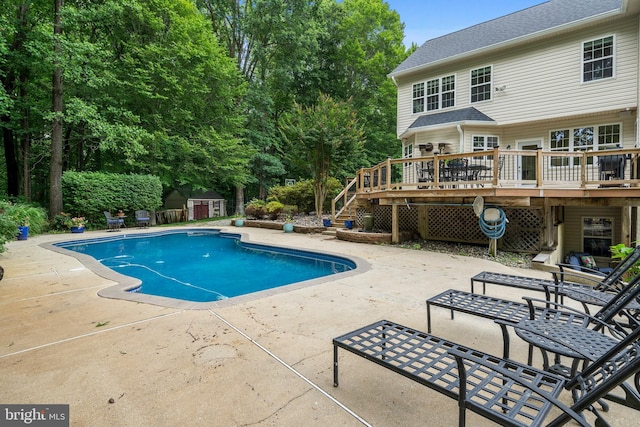 3740 Devin Ct, Huntingtown, MD 20639 - view of swimming pool featuring stairs, a deck, a patio area, and view of wooded area