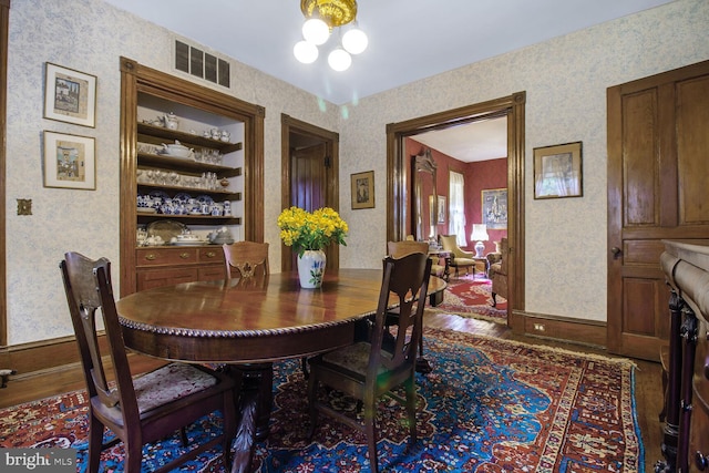 3911 Prospect St, Kensington, MD 20895 - dining space with wood finished floors, baseboards, and wallpapered walls