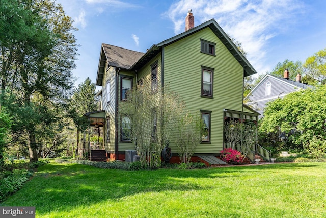 3911 Prospect St, Kensington, MD 20895 - back of house with a yard, a chimney, central AC, and a shingled roof