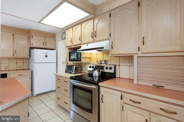 121 S Central St, Broadway, VA 22815 - kitchen with stainless steel range with electric stovetop, freestanding refrigerator, range hood, light brown cabinets, and black microwave