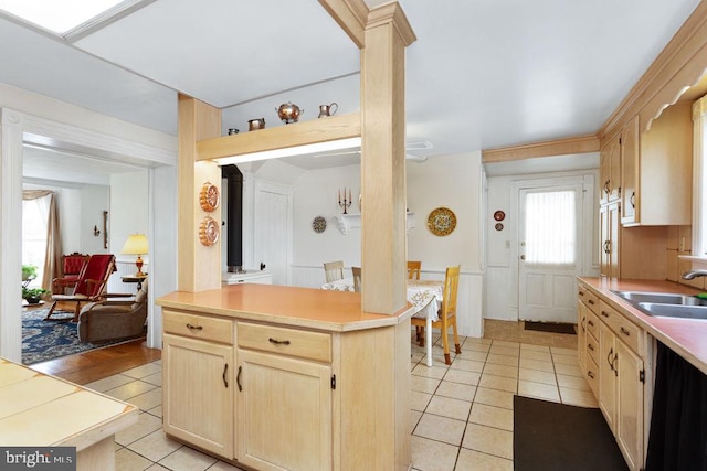 121 S Central St, Broadway, VA 22815 - kitchen with light brown cabinets, light tile patterned floors, a sink, light countertops, and decorative columns