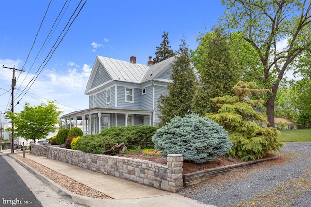 121 S Central St, Broadway, VA 22815 - view of side of home featuring a standing seam roof, a chimney, a sunroom, and metal roof