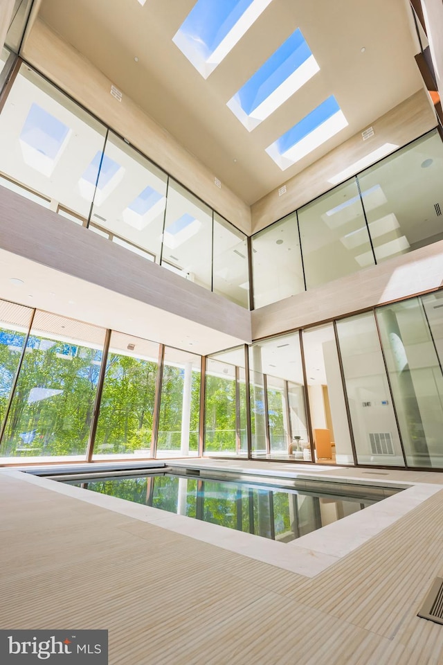 view of swimming pool featuring a skylight