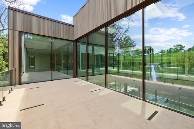 view of exterior entry featuring a patio area