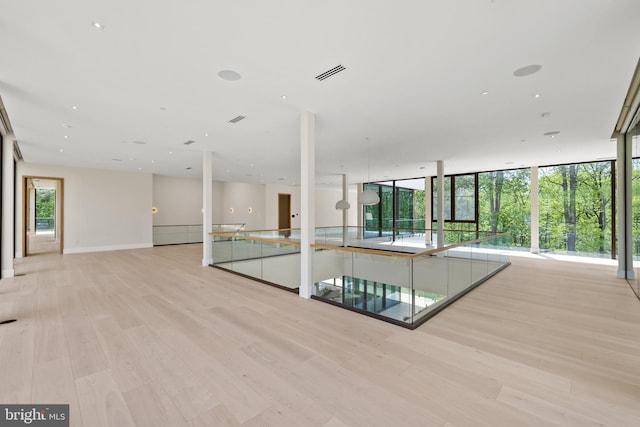 unfurnished room with light wood-style floors and baseboards