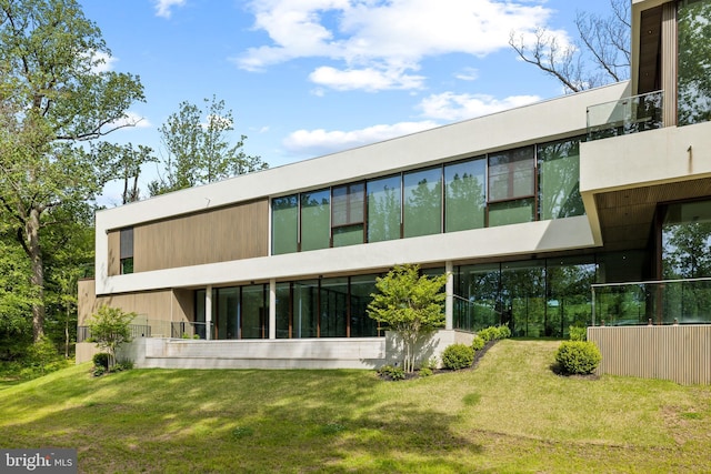 rear view of property with a yard