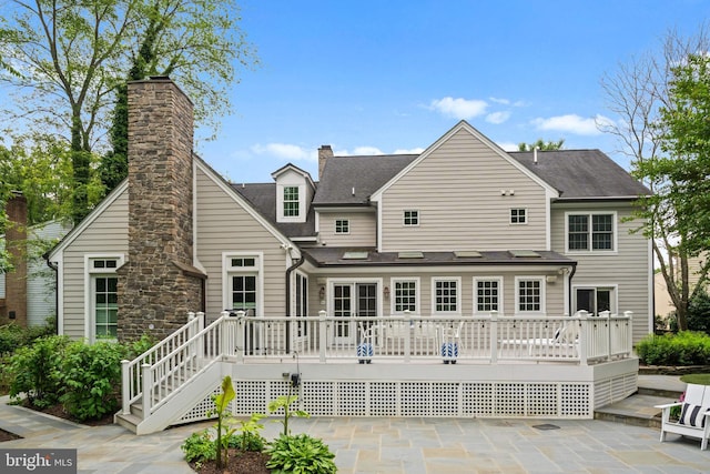 2125 Rampart Dr, Alexandria, VA 22308 - back of property featuring a wooden deck, a patio area, and roof with shingles