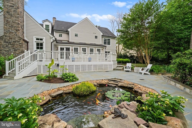 2125 Rampart Dr, Alexandria, VA 22308 - rear view of house with a small pond, a patio, and a deck