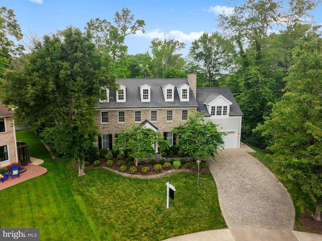2125 Rampart Dr, Alexandria, VA 22308 - view of front of house featuring a chimney, decorative driveway, a garage, and a front yard