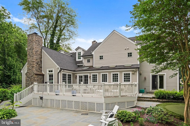 2125 Rampart Dr, Alexandria, VA 22308 - back of property featuring a putting area, a patio, a chimney, and a deck