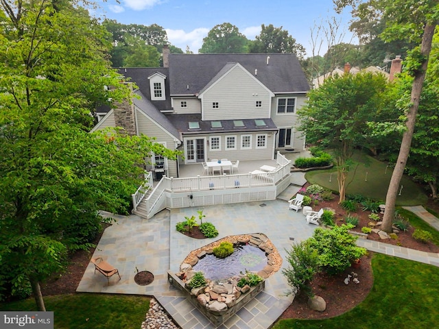 2125 Rampart Dr, Alexandria, VA 22308 - back of property with a patio area, a deck, a chimney, and stairs