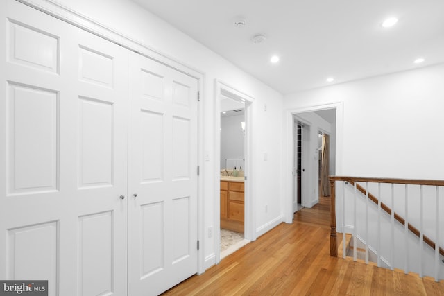 2125 Rampart Dr, Alexandria, VA 22308 - corridor featuring light wood-type flooring, recessed lighting, baseboards, and an upstairs landing