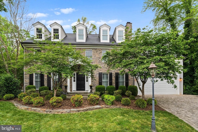 2125 Rampart Dr, Alexandria, VA 22308 - view of front facade featuring a front yard, driveway, a garage, and a chimney