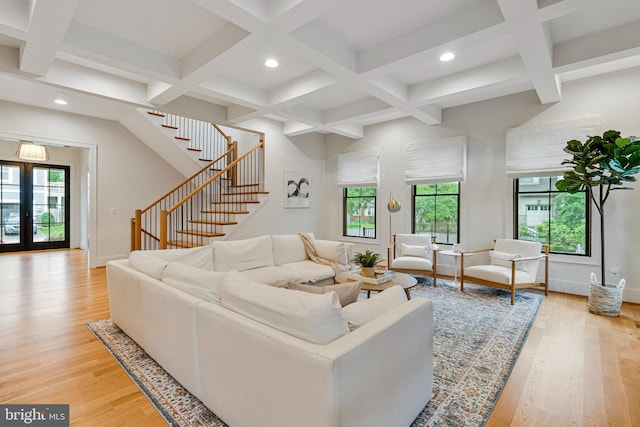 living area with coffered ceiling, healthy amount of natural light, recessed lighting, stairway, and light wood-type flooring