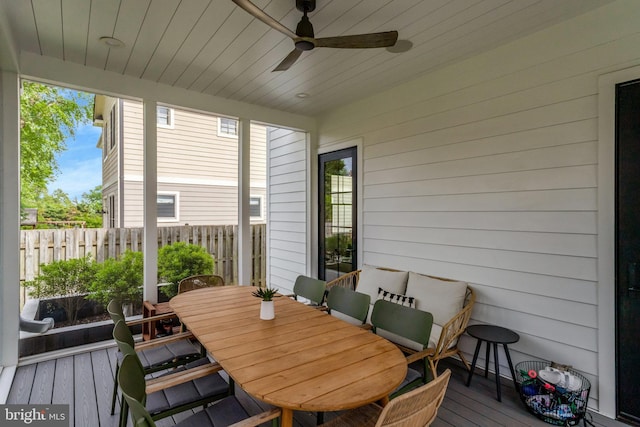 sunroom with ceiling fan, healthy amount of natural light, and outdoor dining space