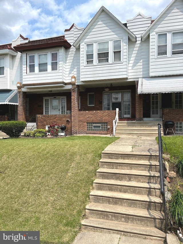 6709 N Lawrence St, Philadelphia, PA 19126 - multi unit property with a porch, brick siding, and a front yard