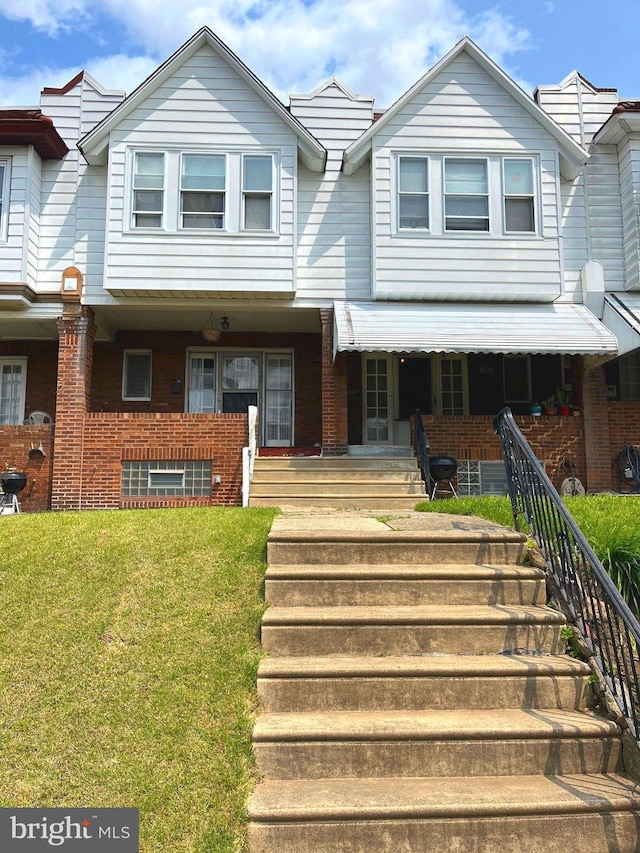 6709 N Lawrence St, Philadelphia, PA 19126 - multi unit property featuring a front lawn, brick siding, covered porch, and stairs