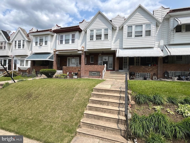 6709 N Lawrence St, Philadelphia, PA 19126 - view of property featuring brick siding, a front yard, and covered porch