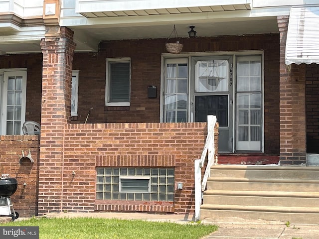 6709 N Lawrence St, Philadelphia, PA 19126 - property entrance featuring brick siding and covered porch