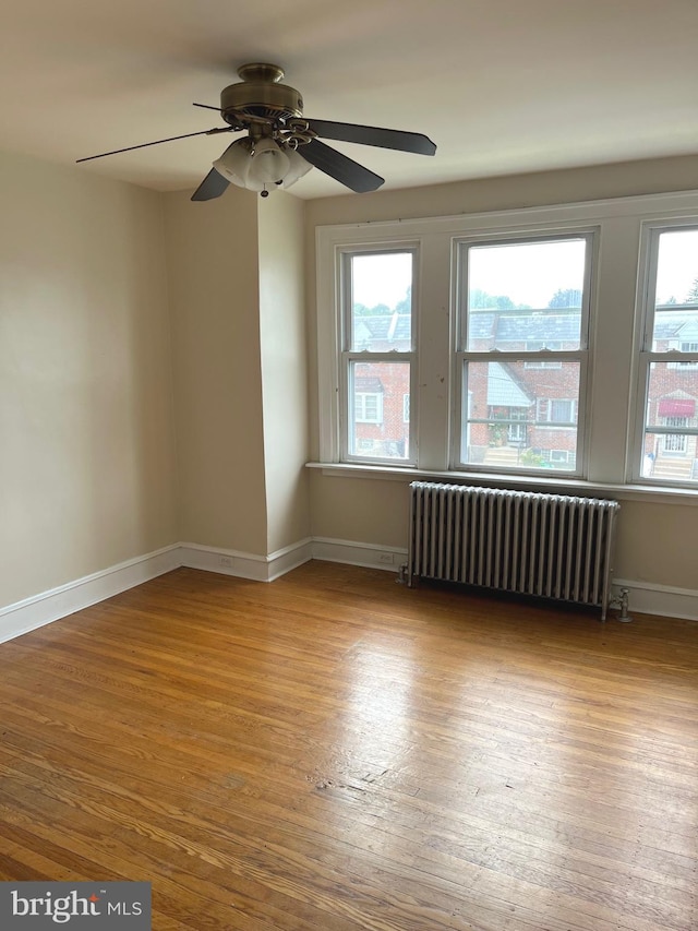 6709 N Lawrence St, Philadelphia, PA 19126 - empty room featuring radiator heating unit, wood finished floors, ceiling fan, and baseboards