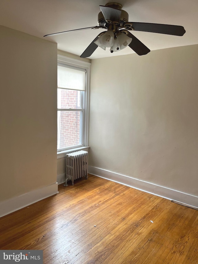 6709 N Lawrence St, Philadelphia, PA 19126 - unfurnished room with radiator heating unit, baseboards, hardwood / wood-style flooring, and ceiling fan