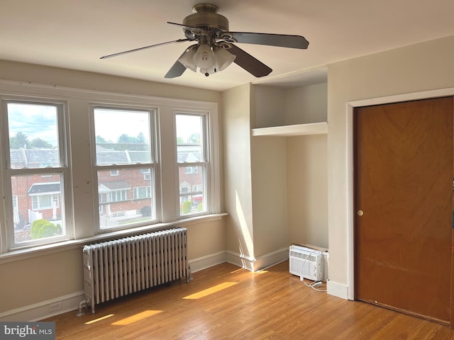 6709 N Lawrence St, Philadelphia, PA 19126 - unfurnished bedroom with radiator heating unit, multiple windows, wood finished floors, and baseboards