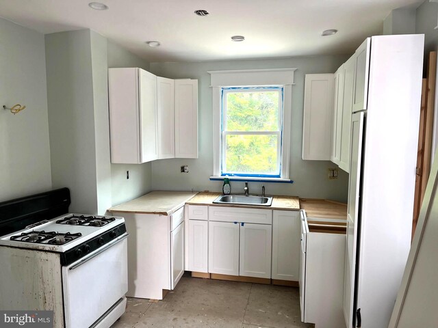 6709 N Lawrence St, Philadelphia, PA 19126 - kitchen with white appliances, a sink, white cabinetry, and light countertops