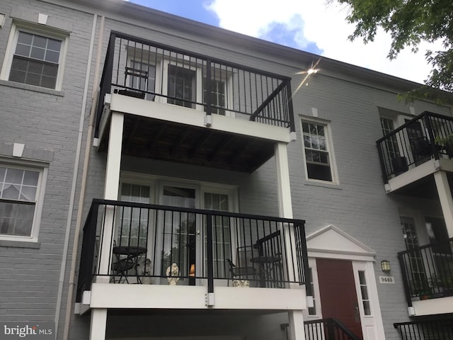 9449 Fairfax Blvd Unit 301, Fairfax, VA 22031 - back of property featuring a balcony and brick siding