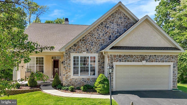 4304 Wheelwright Trl, Downingtown, PA 19335 - view of front of home with stone siding, a chimney, an attached garage, and asphalt driveway