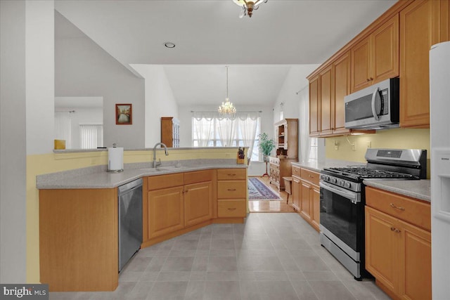 4304 Wheelwright Trl, Downingtown, PA 19335 - kitchen with appliances with stainless steel finishes, vaulted ceiling, a chandelier, light countertops, and a sink