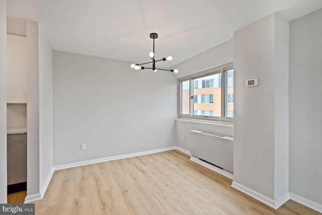 4520 King St Unit 609, Alexandria, VA 22302 - unfurnished dining area with a chandelier, light wood finished floors, and baseboards
