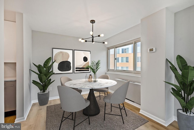 4520 King St Unit 609, Alexandria, VA 22302 - dining room with a chandelier, light wood-type flooring, and baseboards