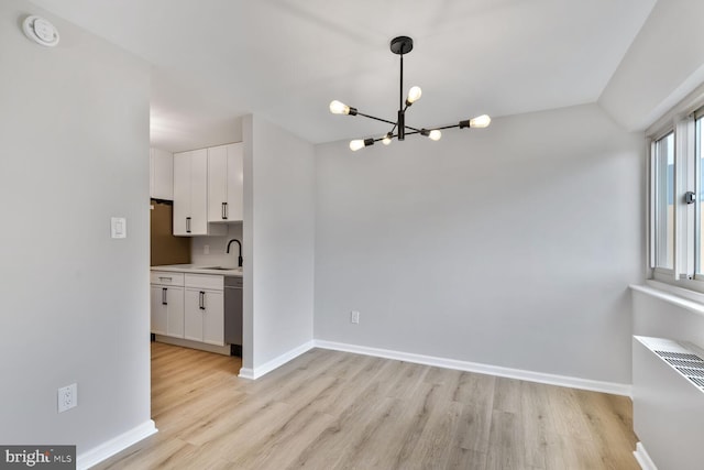 4520 King St Unit 609, Alexandria, VA 22302 - unfurnished dining area with a chandelier, light wood-style floors, and baseboards