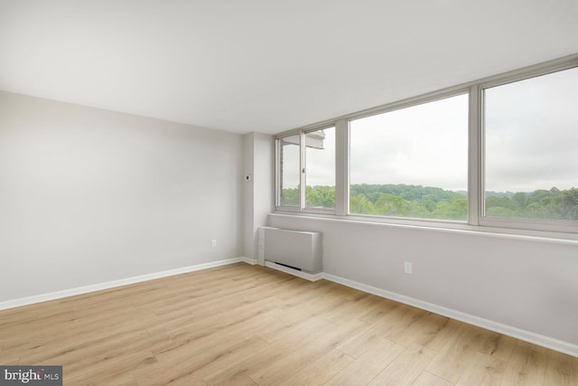 4520 King St Unit 609, Alexandria, VA 22302 - spare room with light wood-style flooring, baseboards, and radiator heating unit