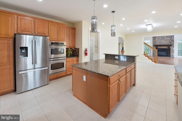 6 Applewood Ct, Hainesport, NJ 08036 - kitchen with appliances with stainless steel finishes, open floor plan, light tile patterned flooring, dark stone countertops, and a kitchen island