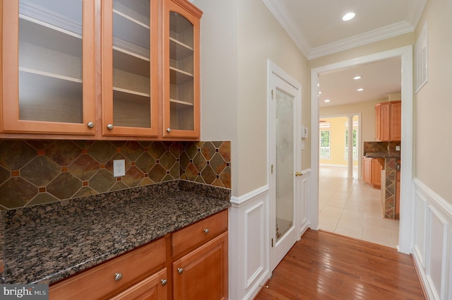 6 Applewood Ct, Hainesport, NJ 08036 - bar area featuring crown molding, a wainscoted wall, light wood-style floors, backsplash, and a decorative wall