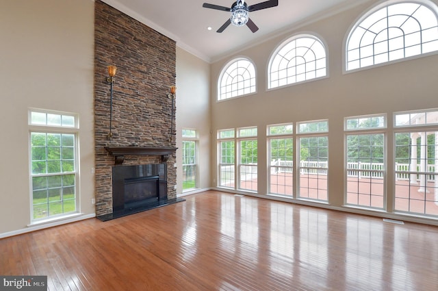 6 Applewood Ct, Hainesport, NJ 08036 - unfurnished living room featuring ceiling fan, a towering ceiling, ornamental molding, hardwood / wood-style floors, and a fireplace