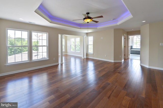 6 Applewood Ct, Hainesport, NJ 08036 - unfurnished room with a tray ceiling, ornate columns, ceiling fan, dark wood-type flooring, and baseboards