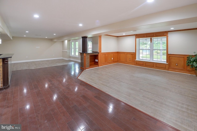 6 Applewood Ct, Hainesport, NJ 08036 - unfurnished living room with a wainscoted wall, dark wood-style flooring, recessed lighting, and ornate columns