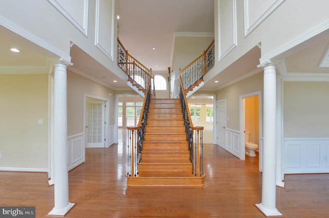 6 Applewood Ct, Hainesport, NJ 08036 - stairway with ornate columns, a decorative wall, wood finished floors, a wainscoted wall, and ornamental molding