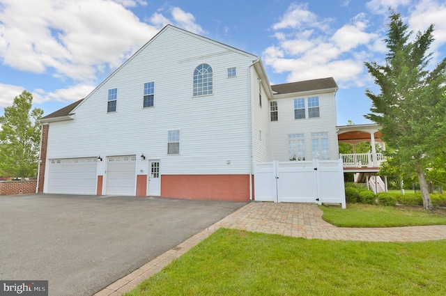 6 Applewood Ct, Hainesport, NJ 08036 - view of side of property with a garage, asphalt driveway, and a gate