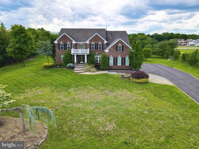 6 Applewood Ct, Hainesport, NJ 08036 - colonial-style house featuring a balcony, brick siding, a front lawn, and asphalt driveway