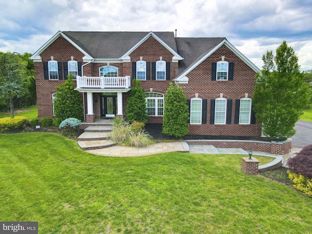 6 Applewood Ct, Hainesport, NJ 08036 - colonial-style house with brick siding, a front yard, and a balcony