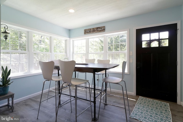 dining area with baseboards, recessed lighting, and wood finished floors
