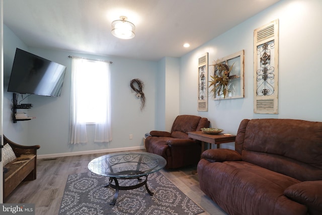 living area featuring wood finished floors and baseboards