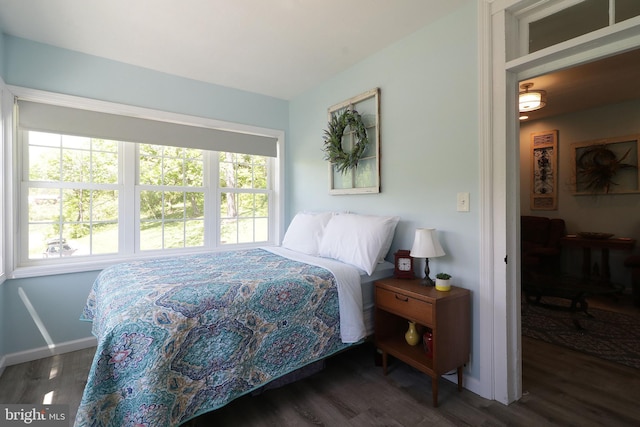 bedroom featuring wood finished floors and baseboards