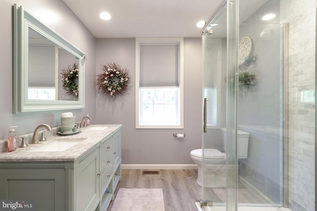 full bathroom with wood finished floors, plenty of natural light, and a stall shower