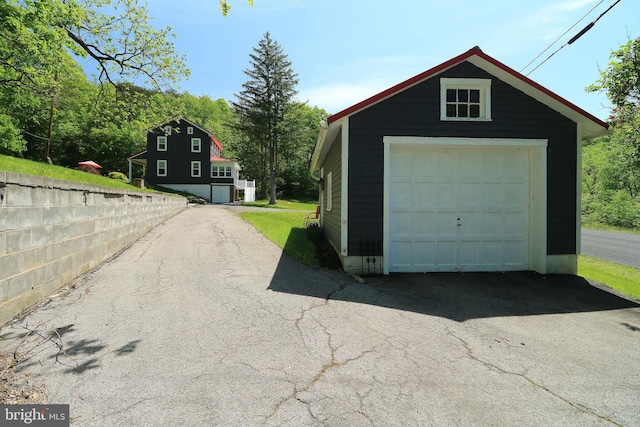 detached garage featuring driveway