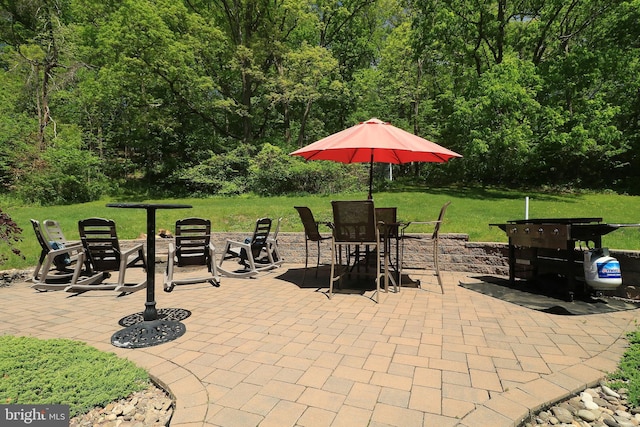 view of patio / terrace with a view of trees