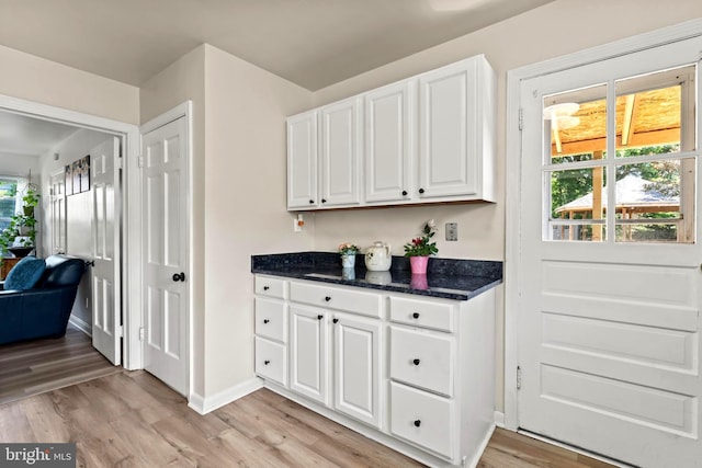 bar area with light wood-style flooring and baseboards